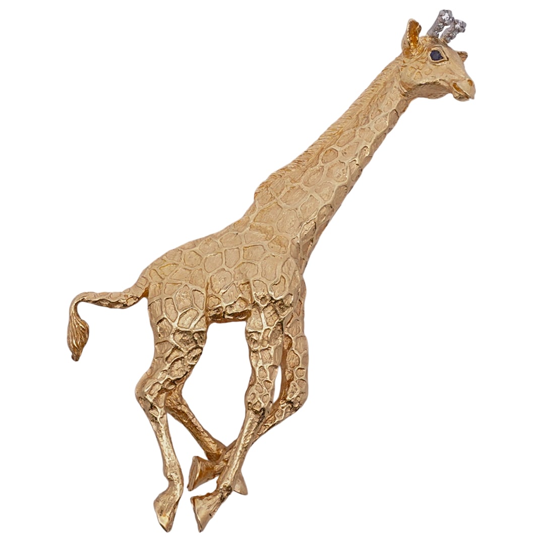 Tiffany & Co. 18k Gold Giraffe Brooch: DESCRIPTION: Tiffany & Co. 18k yellow gold brooch, depicting a giraffe with a satin finish, sapphire inset eyes and small diamonds inset in each horn. Hallmarked "Tiffany & Co. 1989 Germany 18k" Total