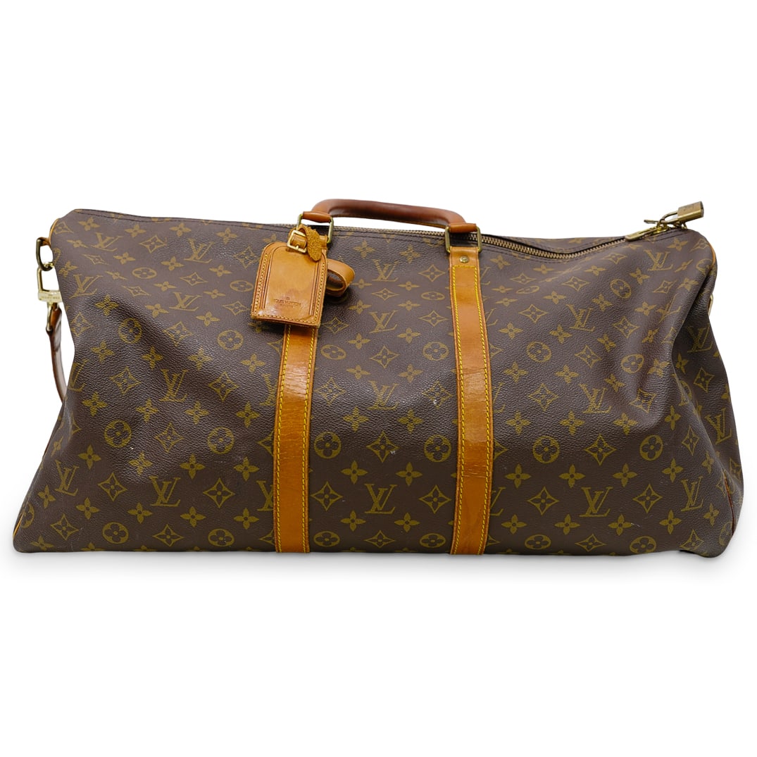 Louis Vuitton Monogram Keepall Bandouliere 55: DESCRIPTION: Louis Vuitton monogram keepall bandouliere 55. This bag is crafted of signature Louis Vuitton monogram on toile coated dark brown canvas. The bag features a vachetta cowhide leather trim,
