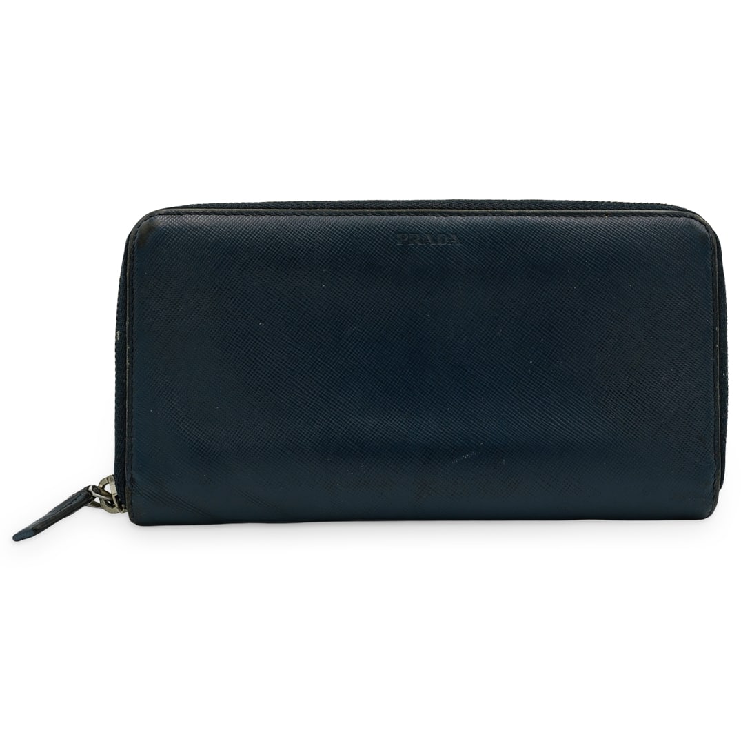 Prada Saffiano Leather Long Wallet: DESCRIPTION: This Prada Saffiano long leather wallet opens up accordian style to a center zip compartment, three slip pockets and card holder slots. Silver tone zip closure on exterior, and Prada embo