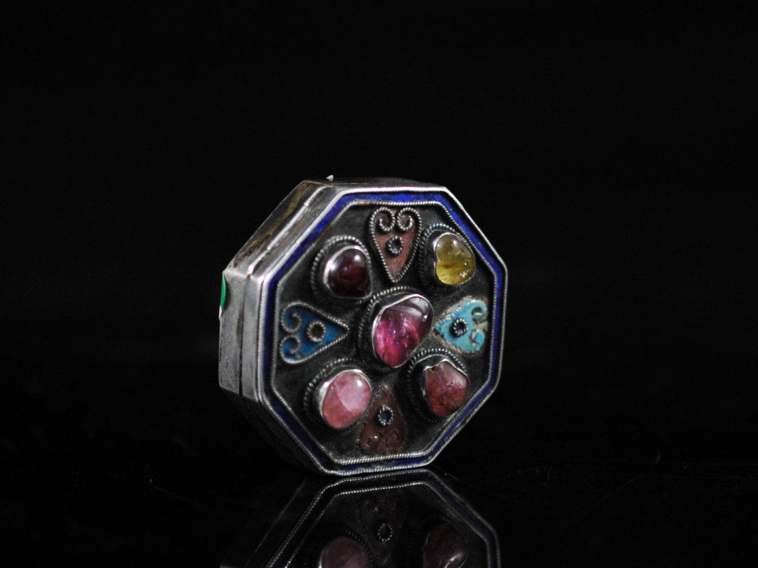 Chinese silver and multi stone pill box: DESCRIPTION: Chinese silver and multi stone pill box. Solid silver body with an enamel and silver filigree design on the lid adorned by five semi precious stones in silver bevels. Hallmarked "China Si