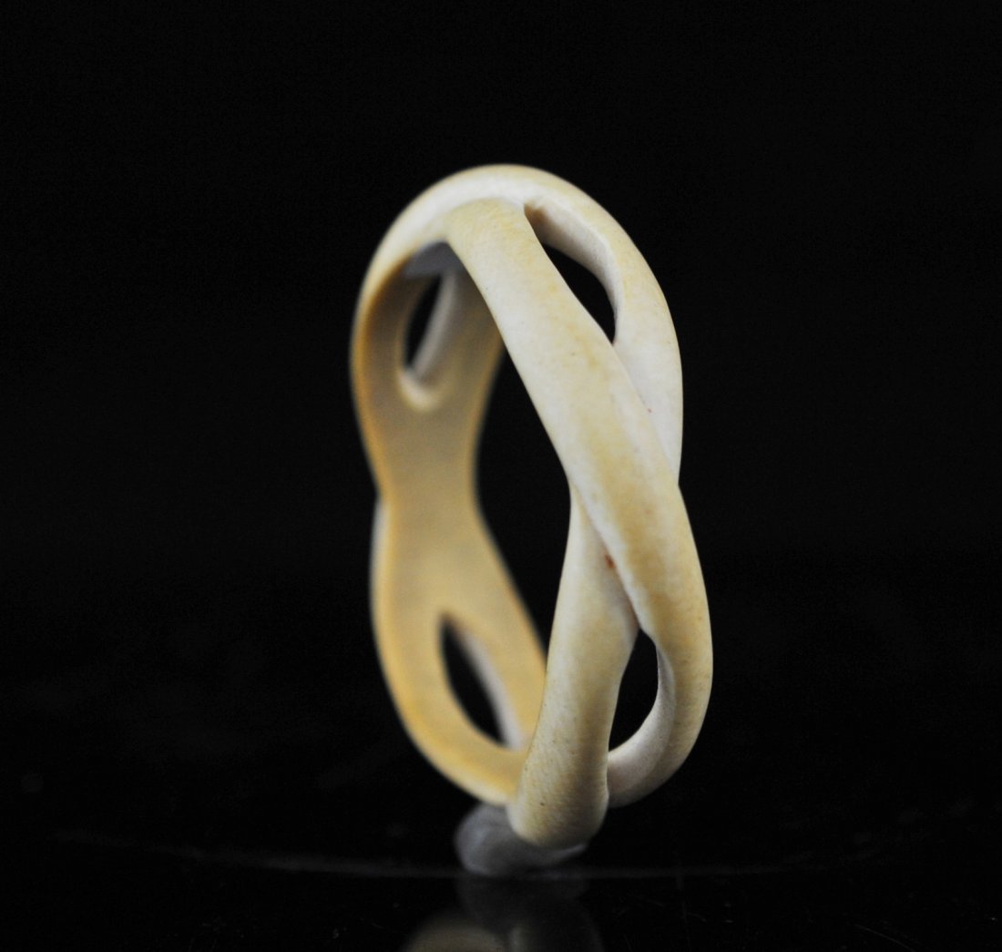 Antique Chinese ivory bangle bracelet: DESCRIPTION: Antique Chinese ivory bangle bracelet. Primitive interwoven design carved from one piece of elephant ivory. Elegant aged patina CIRCA: Early 1900's ORIGIN: China DIMENSIONS: H: 3" L: 0.75