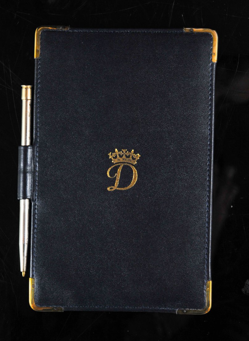 Princess Diana's leather and gold memorandum: DESCRIPTION: Princess Diana's leather and gold memorandum. Given from Princess Diana to her butler Paul burrell. Features a black leather memorandum notebook with 12k gold corners (Marked 1/30 12k) an