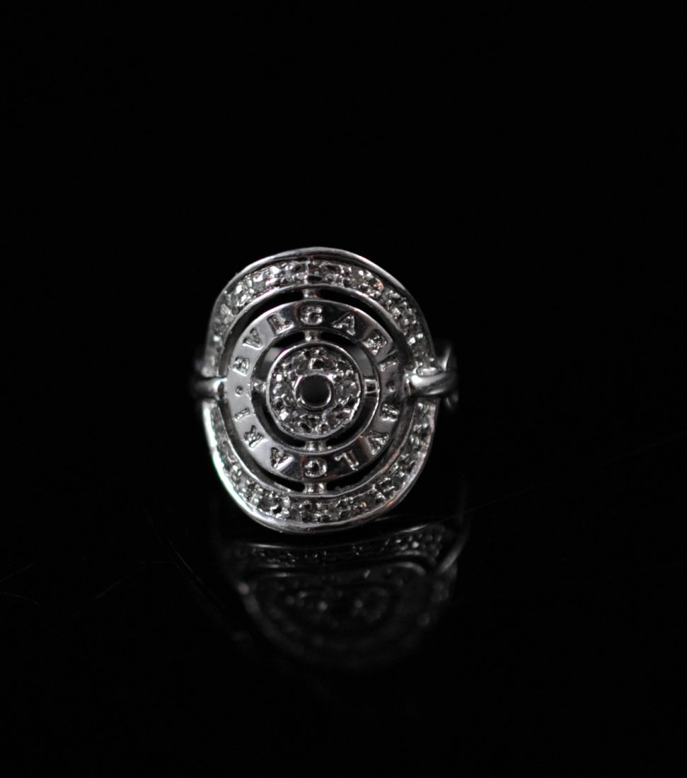 Vintage Bulgari sterling leisure ring: DESCRIPTION: Vintage Bulgari sterling leisure ring. Engraved "Bulgari design with small diamond chips around the border. Marked 925 on the inside band. 6 grams CIRCA: 1970's-1980's ORIGIN: Italy DIMEN