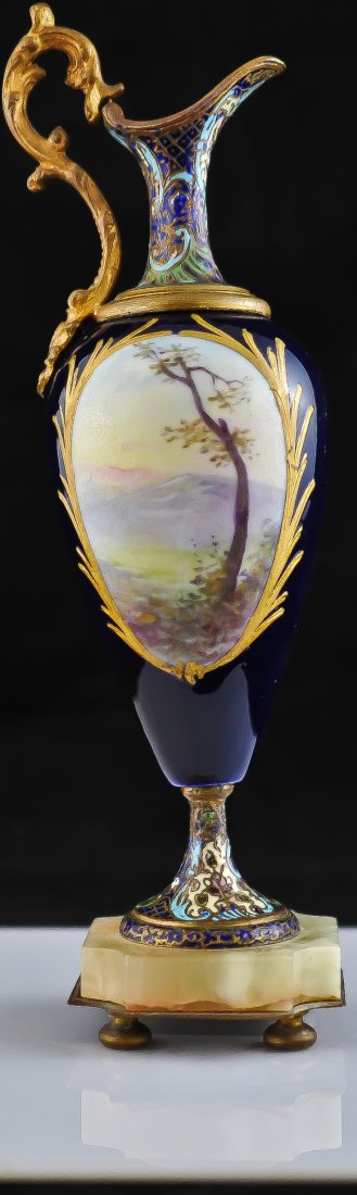 Sevres & champleve hand painted porcelain pitcher: DESCRIPTION: Sevres hand painted small porcelain pitcher mounted on a footed marble base. Scene of two women in a courtyard at play. Reverse painting is of rolling hills. Gold design surrounds the pai