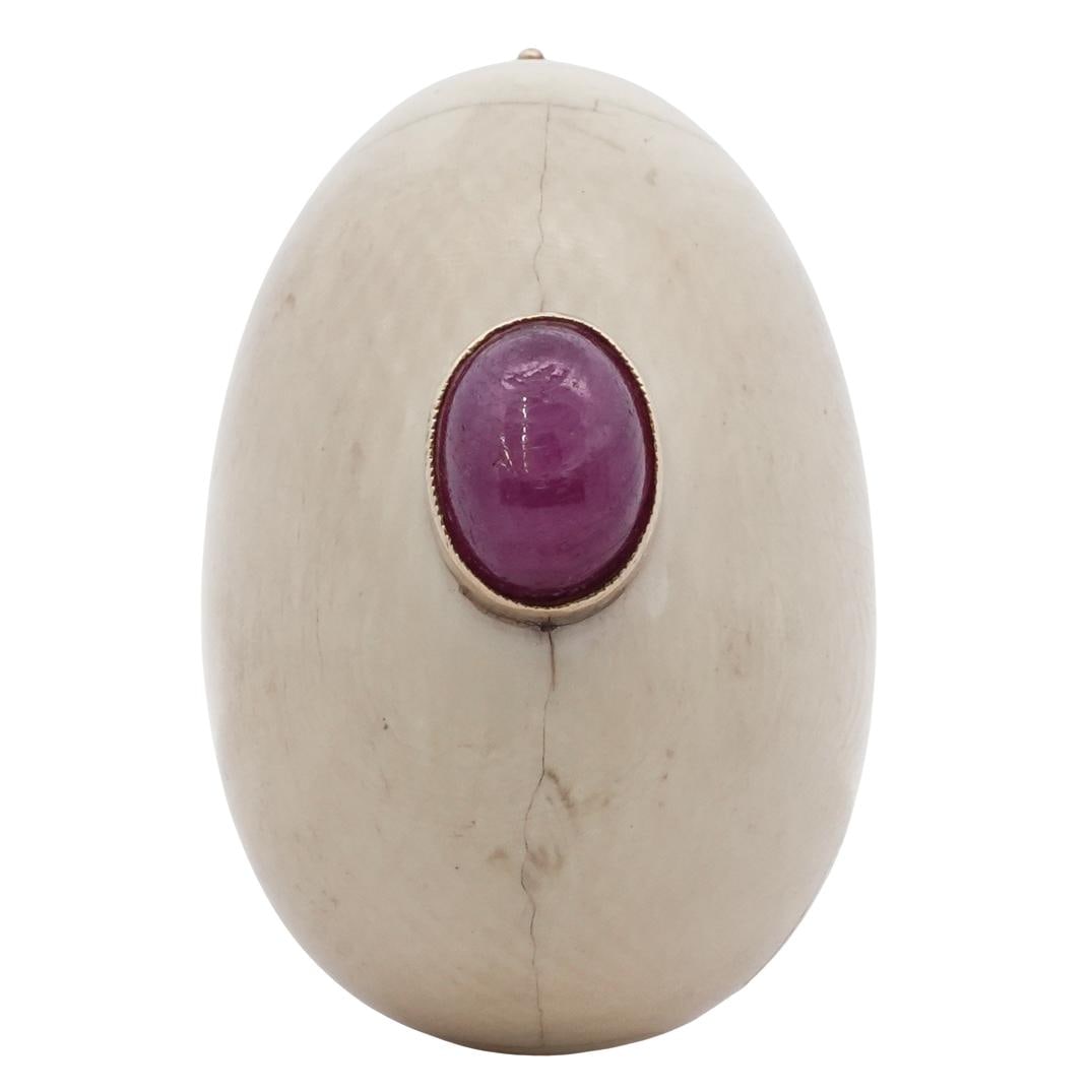 Antique 14k Gold Carved Bone Egg Brooch: DESCRIPTION: Antique carved bone brooch, in the form of an egg with a ruby cabochon at the center in a 14k gold bezel and 14k gold pin backing. CIRCA: Late 19th Century ORIGIN: Continental DIMENSIONS: