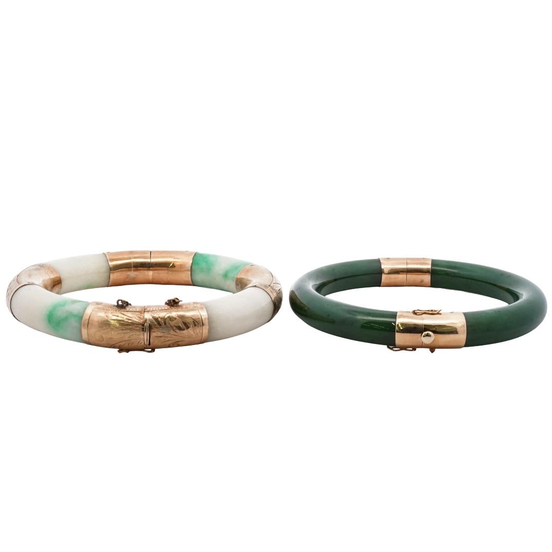 Pair of 14k Gold and Jade Bangles: DESCRIPTION: 14k gold and jade hinged bangle bracelets, one featuring nephrite jade and two panels of 14k gold, hallmarked at clasp "14K 585 GUMPS" The other featuring a lighter jade with four panels