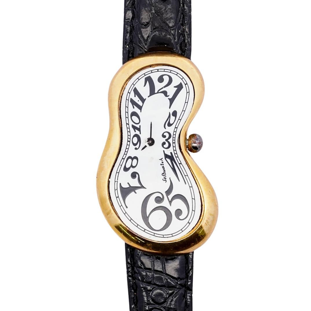 1990's Salvador Dali Softwatch in Black and Gold: DESCRIPTION: 1990-1999 Exaequo Softwatch. Designed after Salvador Dali's famous painting "The Persistence of Memory". Genuine leather black band with alligator-style texture. White enamel watch face w