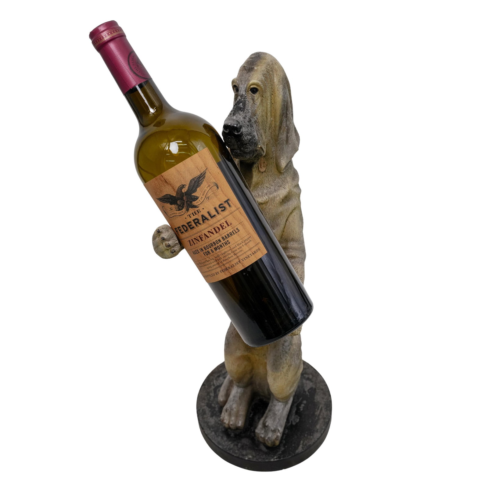 Vintage Bombay Co. Dog Wine Holder: DESCRIPTION: Vintage wine holder by Bombay Co. crafted as a dog, on a round stone base. CIRCA: 20th Century ORIGIN: USA DIMENSIONS: H: 17.5" W: 7.5" L: 6.5" CONDITION: Good condition Unless otherwise 