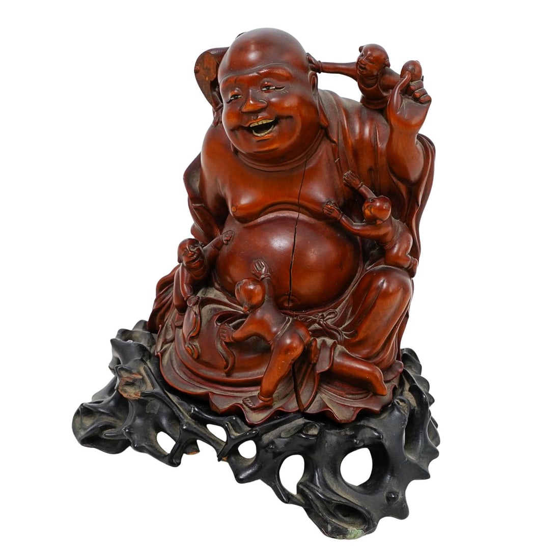 Antique Carved Wooden Buddha Sculpture: DESCRIPTION: Antique carved wooden Buddha on stand, made from warm toned hardwood and highly detailed, particularly in his facial expression, robe drapery, and the joyful children surrounding him. Bud