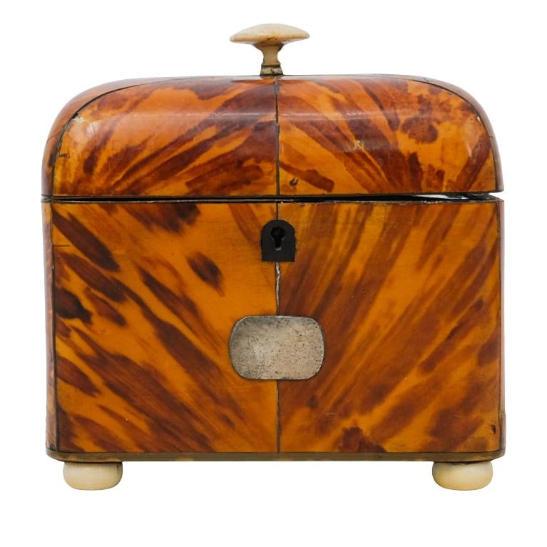 English Victorian Tortoise Hued and Carved Bone Tea Caddy: DESCRIPTION: English Victorian era tortoise hued tea caddy, featuring a rounded carved bone finial handle, opening up to two separate compartments with tortoise hued tops that each have small round ca