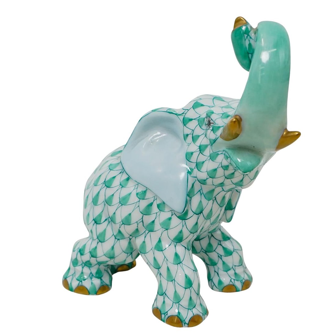 Herend Porcelain "Joyful Elephant" Green Fishnet Figurine: DESCRIPTION: Herend porcelain figurine of a "Joyful Elephant" embellished in a green hued fishnet pattern. Finished with gilded accents. Style:#15266. Marked along the underside with Herend stamps. CI