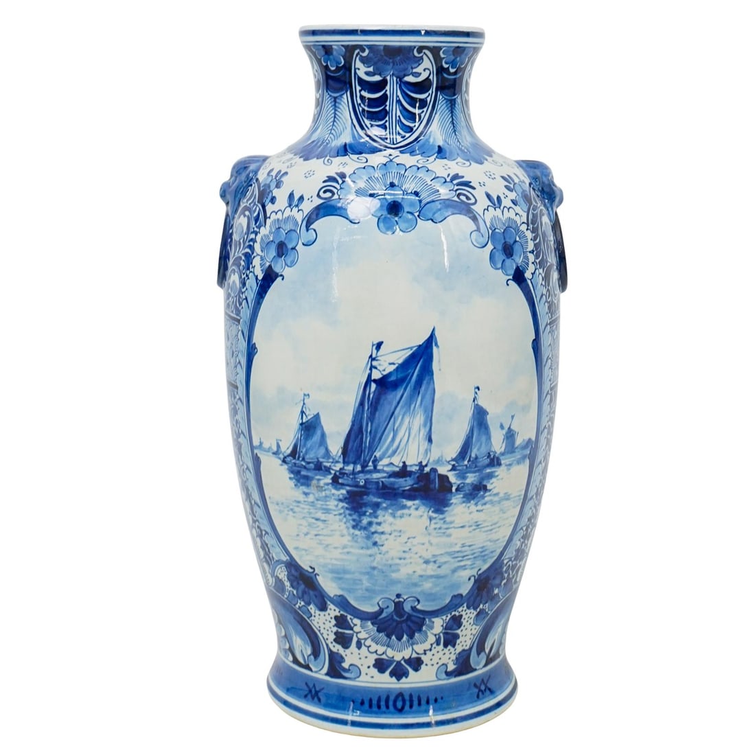 Antique Dutch Blue and White Porcelain Vase: DESCRIPTION: Antique Dutch porcelain vase, featuring intricate blue and white hand painted designs. One side is decorated with a pastoral scene with windmills by the water, bordered in florals and scr