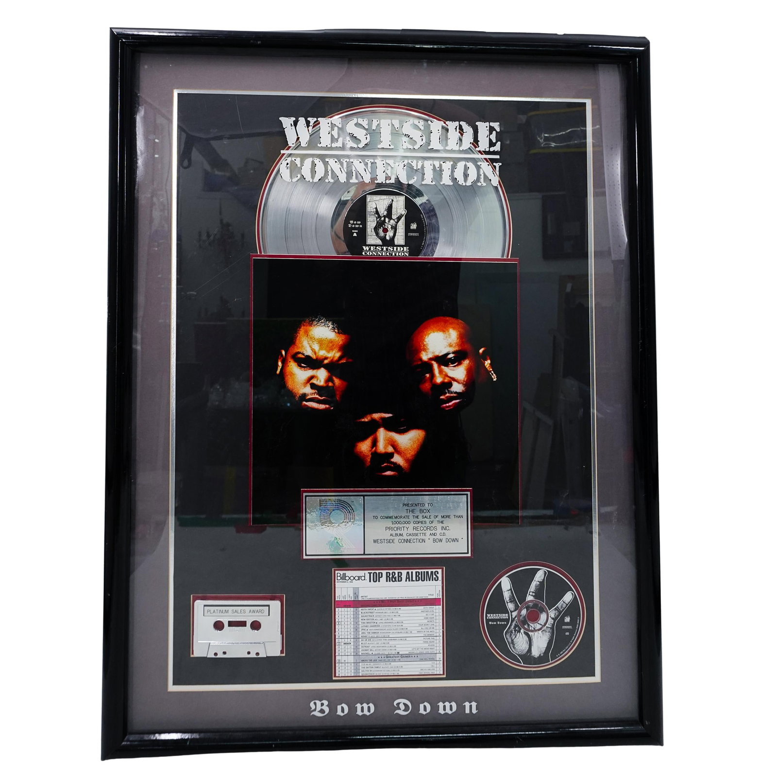 Westside Connection "Bow Down" Band Sales Record Award: DESCRIPTION: Westside Connection "Bow Down" Band Sales Record Award. Presented on a display frame. Presented to The Box. to commemorate the Platinum Sale Award for more than 1,000,000 copies of the Pr