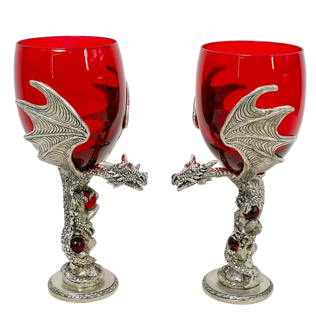(2 pcs) Fellowship Foundry 1997 Dragon Wine Glasses: DESCRIPTION: Fellowship Foundry Pewtersmiths pewter and fine crystal wine glasses. Feature hand-carved pewter dragons with red crystal embellishments. Glass is fine red crystal and holds 12 oz of liqu