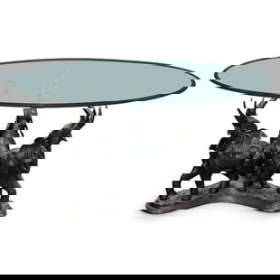 Bronze Elephant Coffee Table: DESCRIPTION: Contemporary coffee table. Glass top on a carved bronze base creating three elephants with raised trunks. Similar to a design by Maitland-Smith. CIRCA: 20th century ORIGIN: Europe DIMENSI