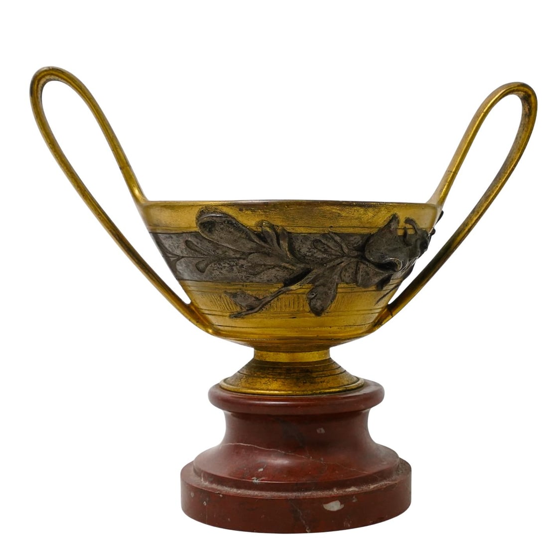 19th Century Silver & Gilt Bronze Amphora: DESCRIPTION: 19th century gilt bronze amphora vase with silver floral detailing. Sits on a red marble base. Marked on bottom with a sticker indicating "bought at auction, .... 1941". CIRCA: 19th centu