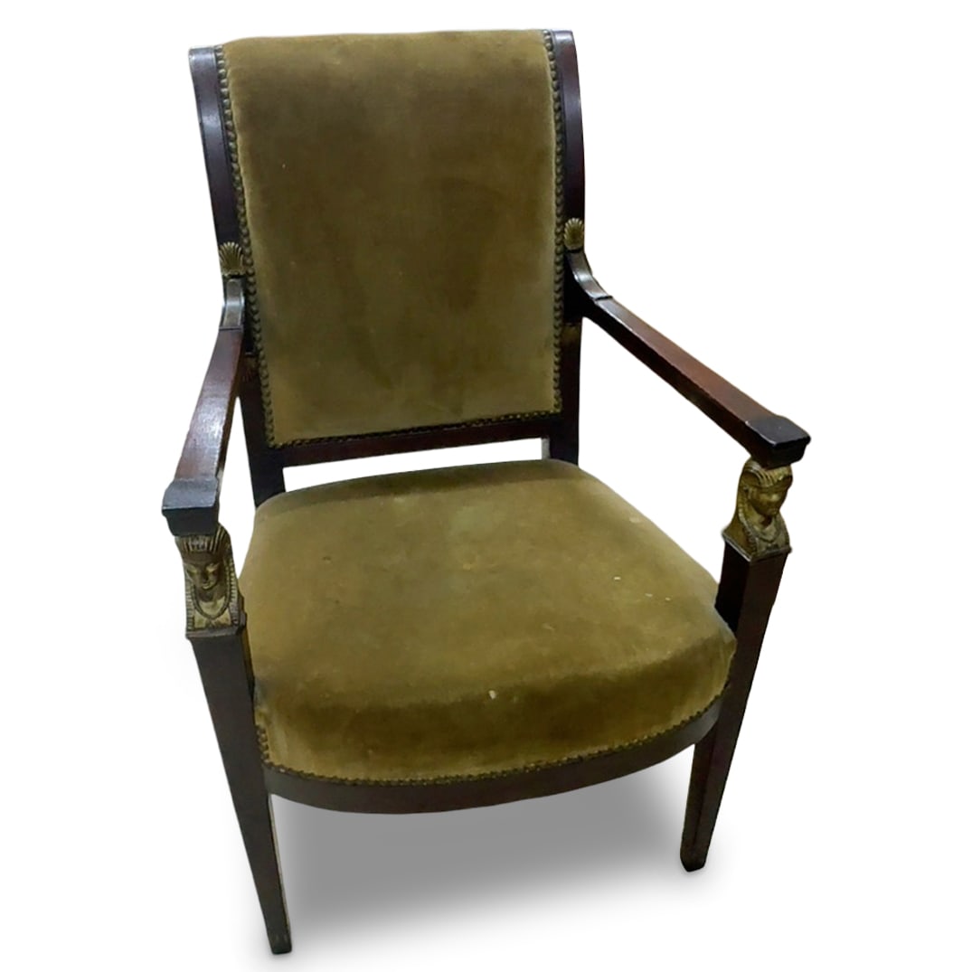 French Empire Egyptian Revival Armchair: DESCRIPTION: French Empire wooden constructed arm chair with Egyptian Pharaoh heads on the arms. Green velvet upholstery. CIRCA: 20th century ORIGIN: Continental DIMENSIONS: H: 35" W: 19" L: 18" CONDI