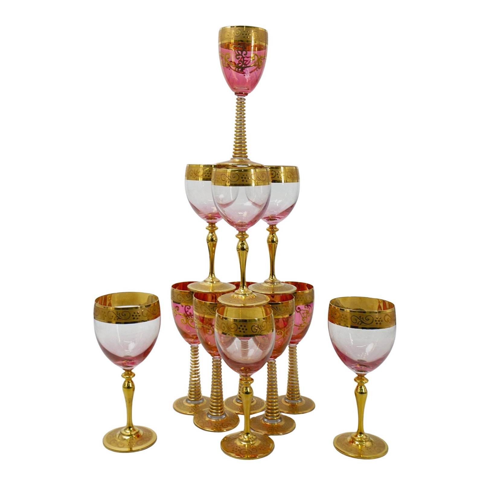 (12 Pc) Bohemian Czech Gold Encrusted Cranberry Glass Goblets Set: DESCRIPTION: (12 Pc) Bohemian Czech Gold Encrusted Cranberry Glass Goblets Set. Designed with clear and cranberry hues, further embellished with gold encrusted patterns, and gilt foot. With signature 