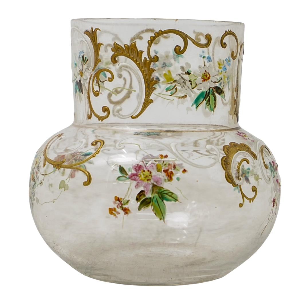Antique French Enamel Glass Vase: DESCRIPTION: Small glass vase hand-painted with floral motifs and filigree in the style of Moser. CIRCA: Early 20th century ORIGIN: France DIMENSIONS: H: 3" W (mouth): 2" L: 3" CONDITION: Great Unless