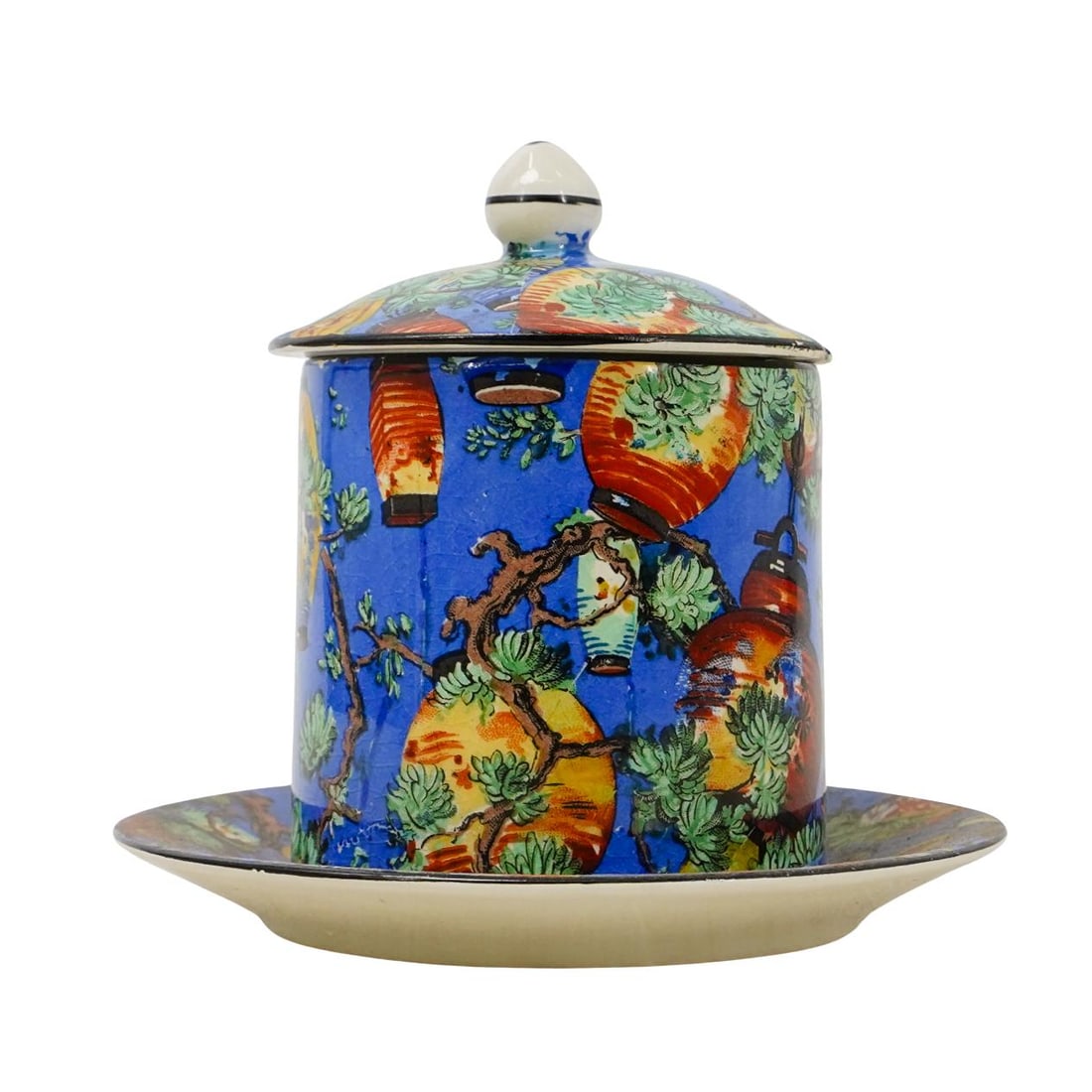 English Porcelain Mustard Jam Lidded Dish: DESCRIPTION: English porcelain mustard or jam lidded dish, with an allover print featuring lanterns and foliage against a blue background. Marked underside "Crown DUCALWARE ENGLAND" CIRCA: 20th Centur