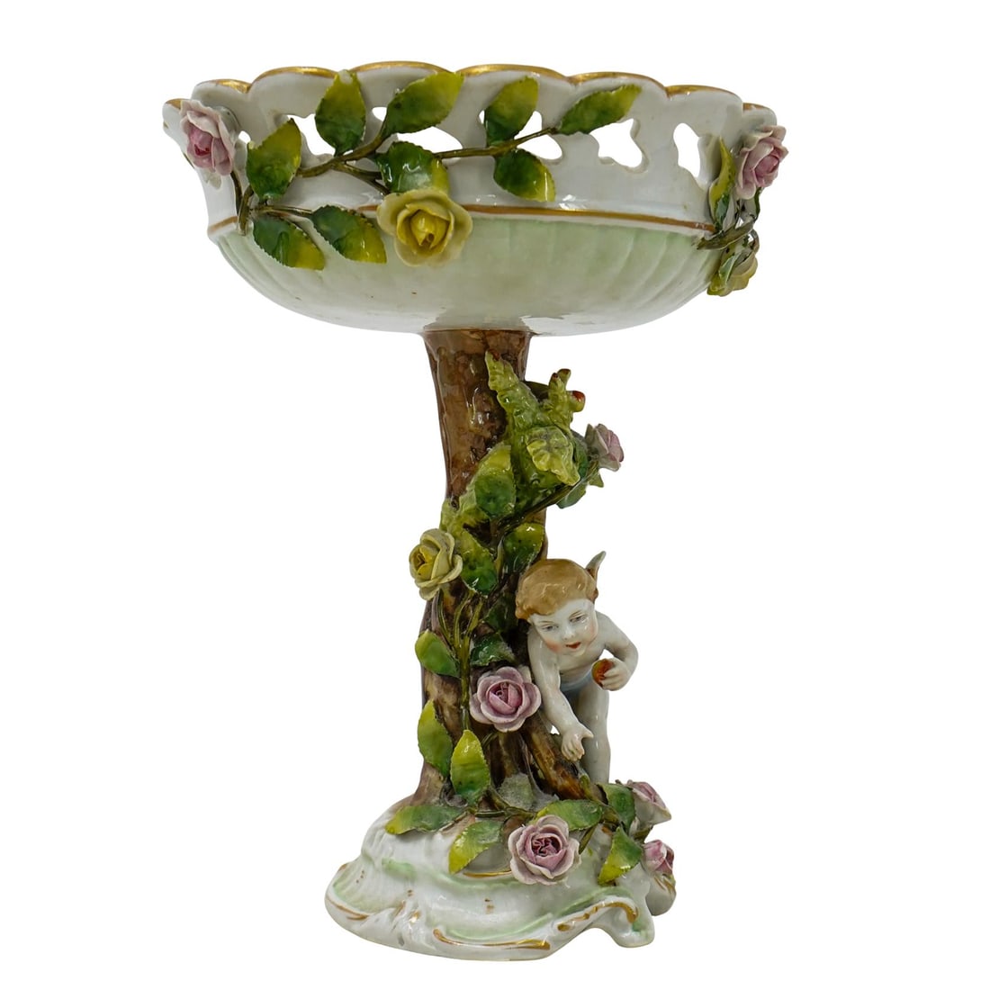 Antique Dresden Porcelain Reticulated Centerpiece: DESCRIPTION: This is an antique Dresden porcelain reticulated centerpiece, crafted with intricate floral details and a cherub figure. The bowl features an openwork, lattice-like rim adorned with porce