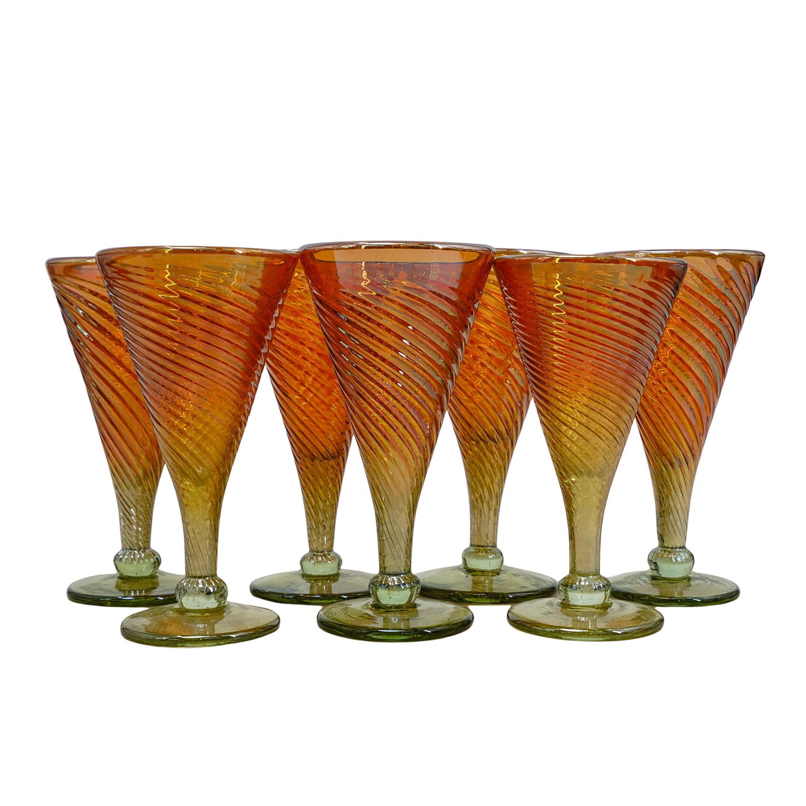 (7 Pc) Rick Strini Iridescent Glass Wine Goblets: DESCRIPTION: Set of (7) Rick Strini iridescent art glass wine goblets, each decorated with a spiral design. Marked along the underside "Strini" CIRCA: 20th Century ORIGIN: USA DIMENSIONS: H: 7" D: 3.7