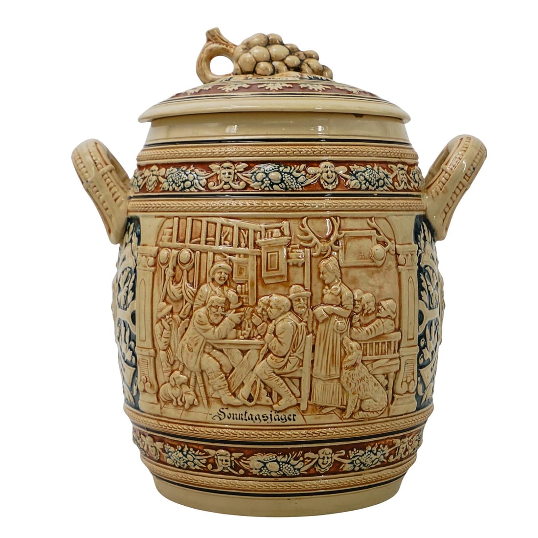 Antique German Majolica Porcelain Liquor Barrel: DESCRIPTION: Antique German majolica porcelain liquor barrel, designed with a pair of figurative interior tavern scenes, and mask motifs in semi relief. Includes a lid with a handle designed as a grap