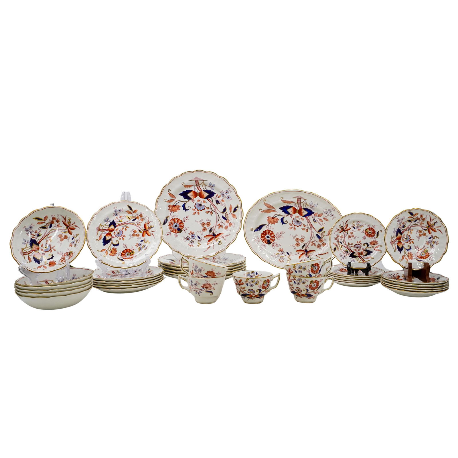 (36 pcs) Booths Fresian England Bone China Set: DESCRIPTION: Booths Fresian England bone china set. Marked on bottom of pieces with "Friesian, England, A8022". Hand-painted floral motifs in reds and blues and gilt accents. x1 Tray L: 12 1/8" W: 9 1