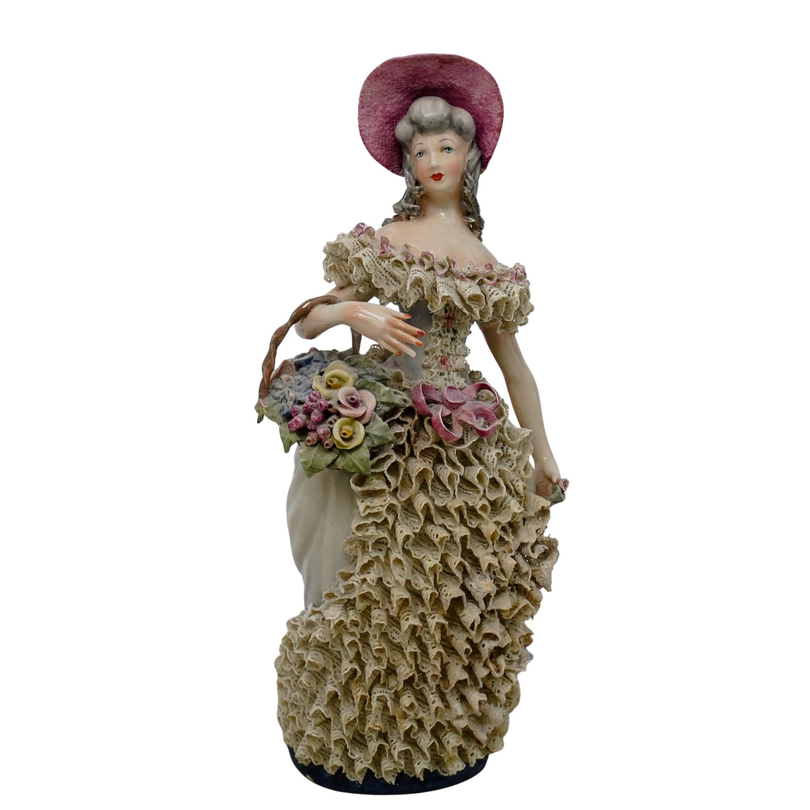 Cordey Porcelain Female Figurine: DESCRIPTION: This is a porcelain figurine of a lady wearing a dress. The gown is highly detailed with delicate lace-like ruffles and pastel-colored floral accents. She is wearing a wide-brimmed pink h