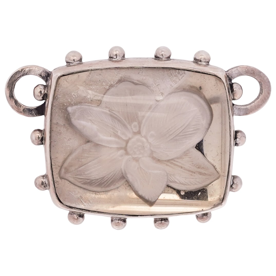 Stephen Dweck Sterling Silver and Rock Crystal Pendant: Stephen Dweck Sterling Silver and Rock Crystal Pendant21st Century, USAStephen Dweck sterling silver pendant, featuring a carved rock crystal flower motif within a sterling silver bezel with beaded ac