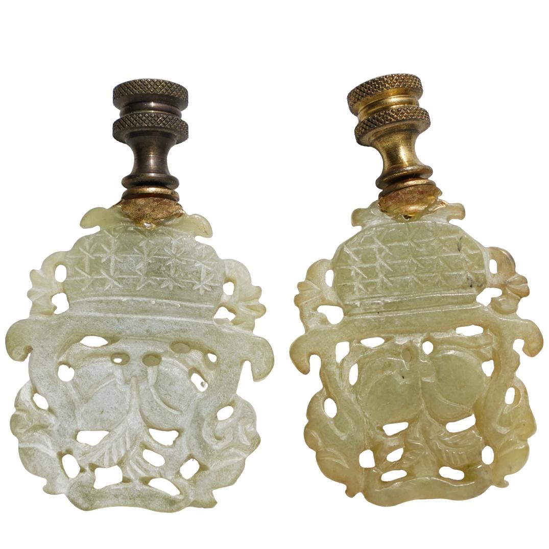 Pair of Antique Chinese jade finials: Pair of Antique Chinese jade finials19th-20th century, ChinaPair of Chinese jade finials with a carved bouquet design and brass hardware.L: 3 1/8" W: 1 7/8"