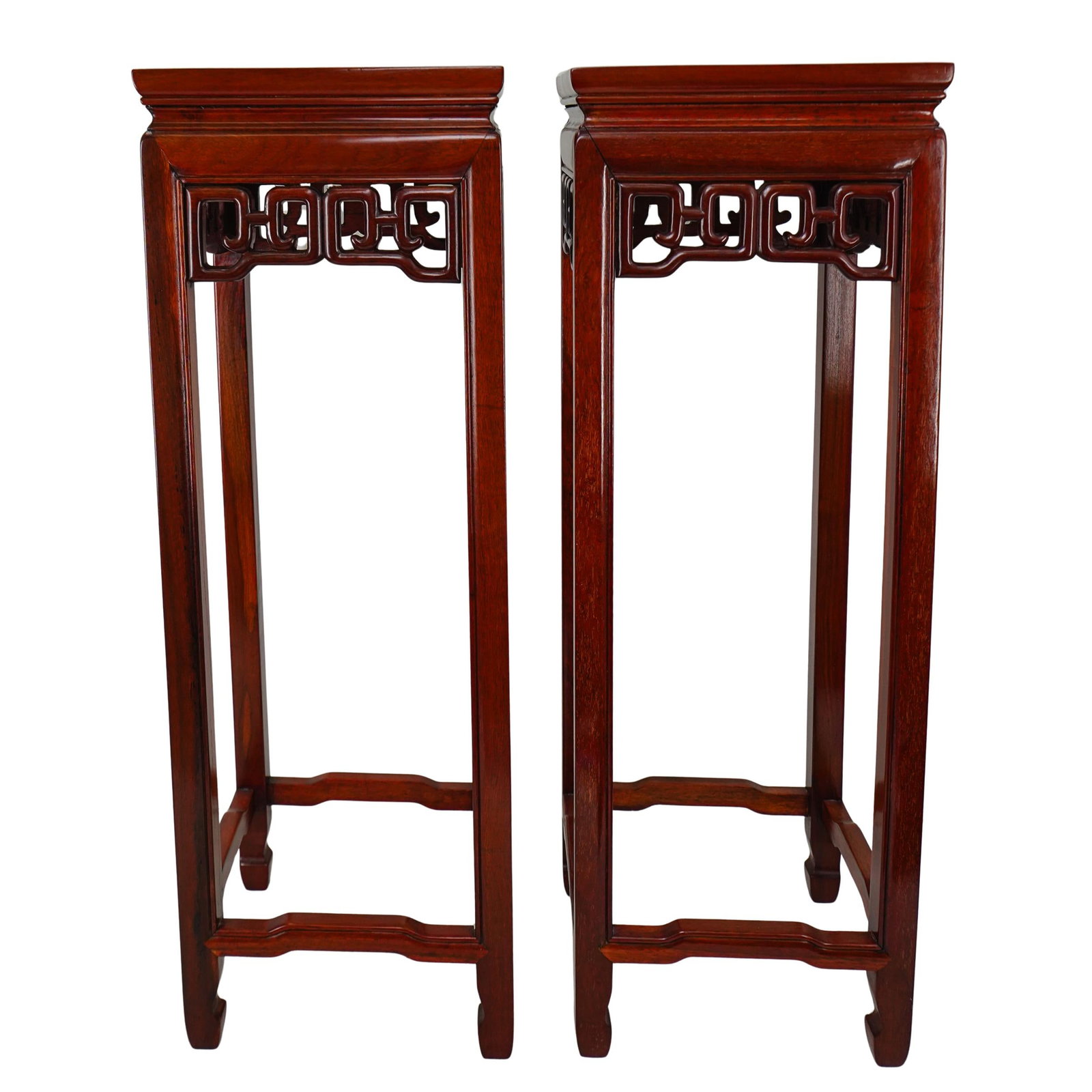 Chinese Carved Wood Pedestals: Chinese Carved Wood Pedestals 20th century Pair of Chinese wooden pedestals with a polished finish. Carved accents in a "meander" or interlocking square pattern. Four legs. Each: H: 32" W (top): 11" L