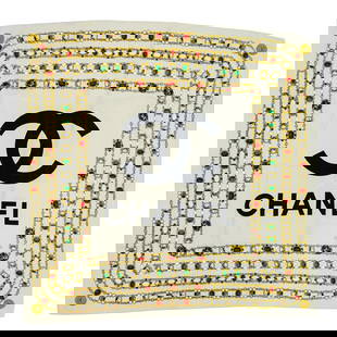Vintage Chanel Scarf: Vintage Chanel Scarf20th century, FranceThis vintage Chanel scarf is made of silk in a light beige tone. The centerpiece prominently features the classic interlocking "CC" Chanel logo in bol