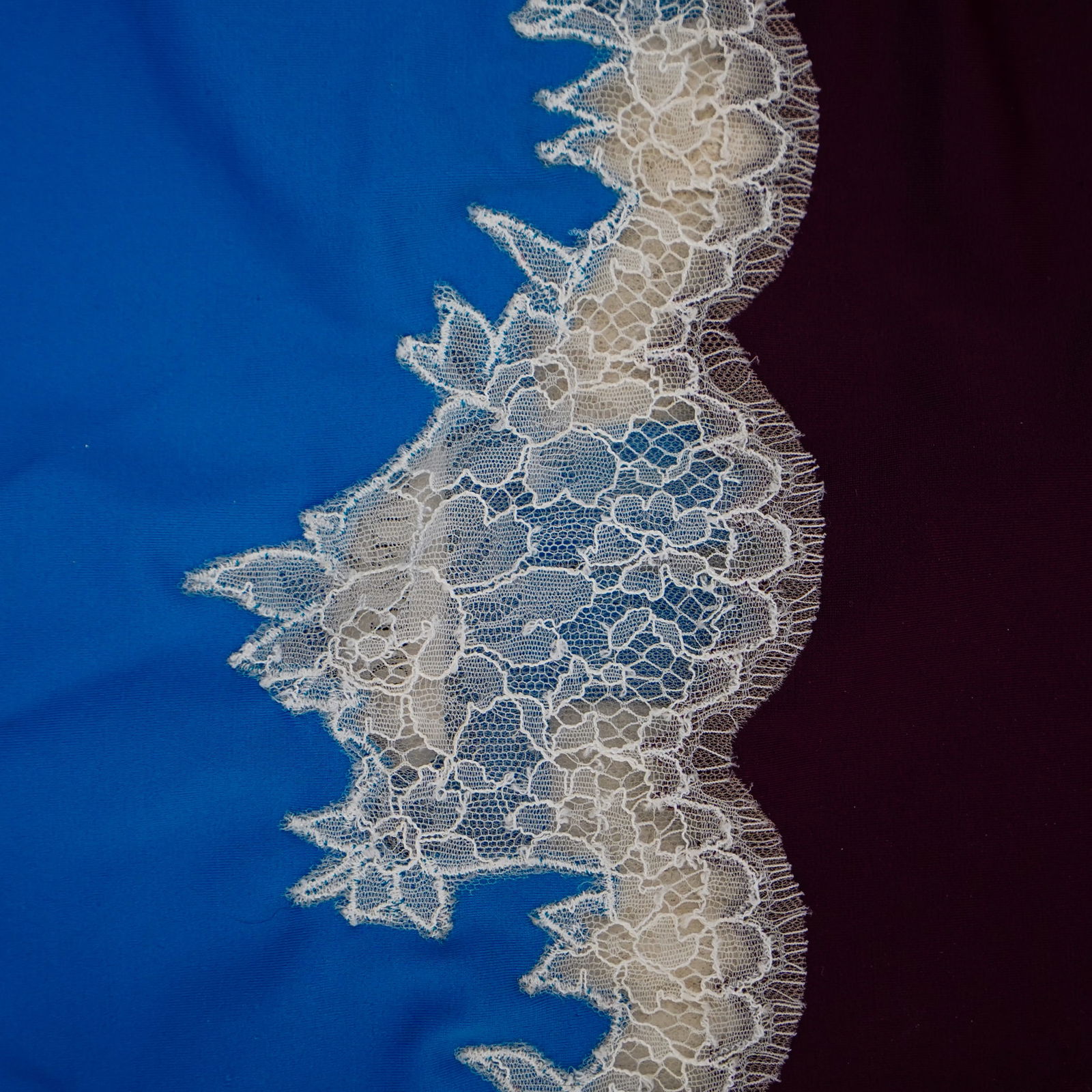 Valentino Lace Trim Colorblock Bodysuit: Valentino Lace Trim Colorblock Bodysuit21st Cent., ItalyThis is a one-piece bodysuit with a form-fitting silhouette. The top section is a rich purple, while the main body is a vibrant cobalt blue. A s