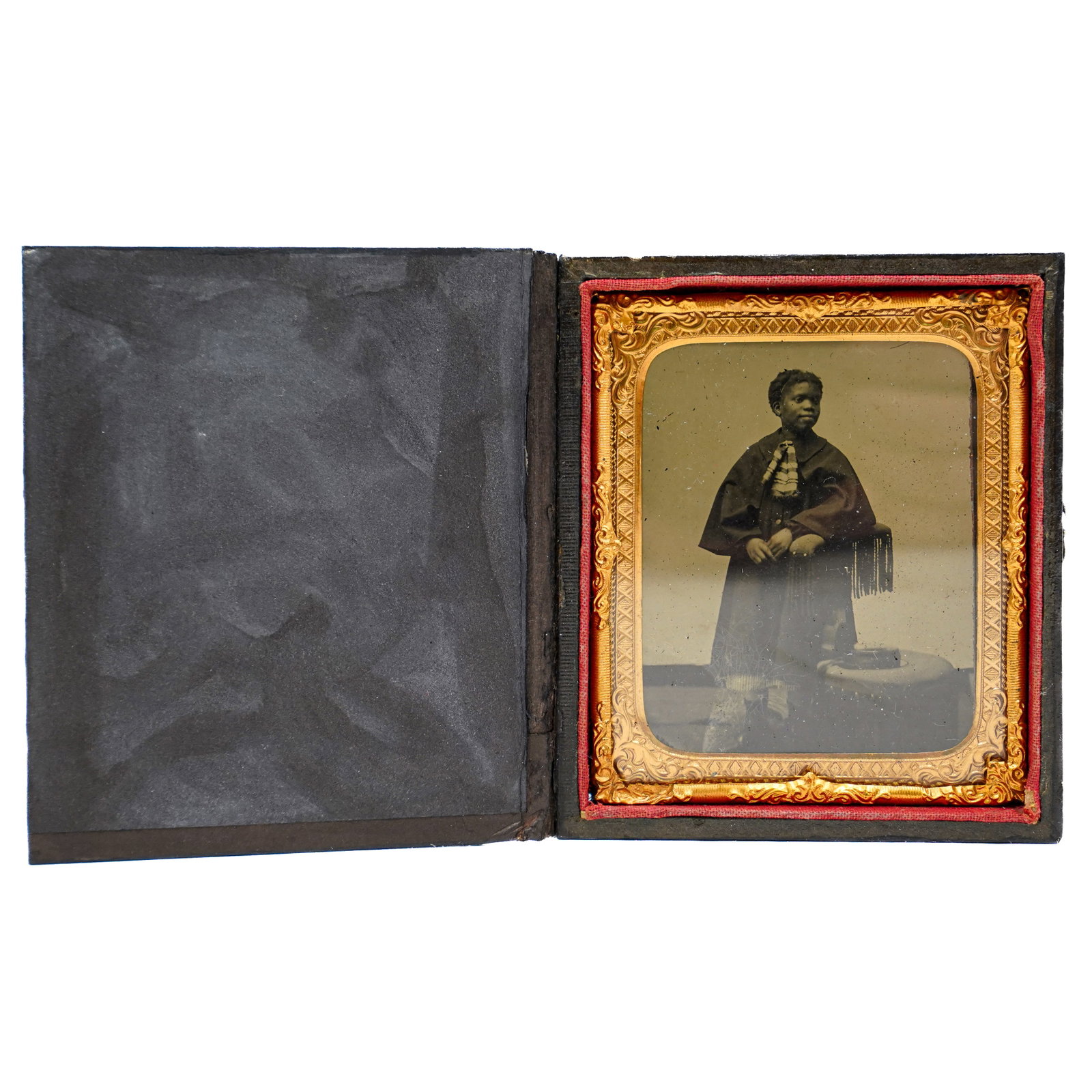Tintype Of African American Woman: Tintype Of African American Woman 19th Century, USA Antique tintype of a young African American woman, posed standing and wearing a dark cloak with fringe over a dress, and a light colored ribbon at h
