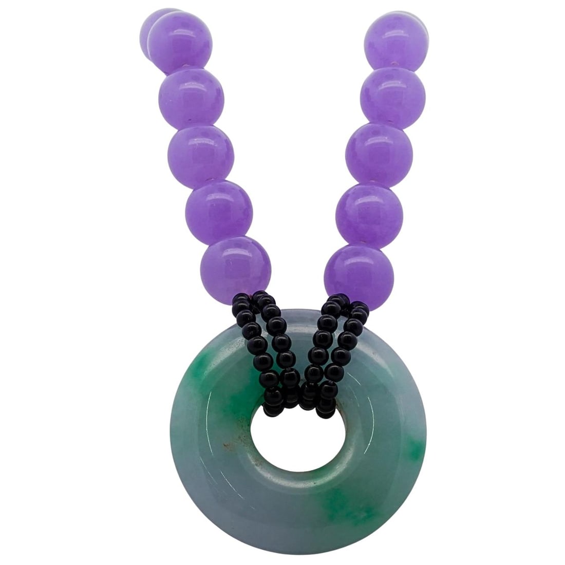 Celadon and Lavender Jade Necklace: Celadon and Lavender Jade Necklace20th century, ChinaThe necklace features a strand of lavender jadeite beads, each one spherical, polished, and uniform in size. The focal point of the necklace is a c