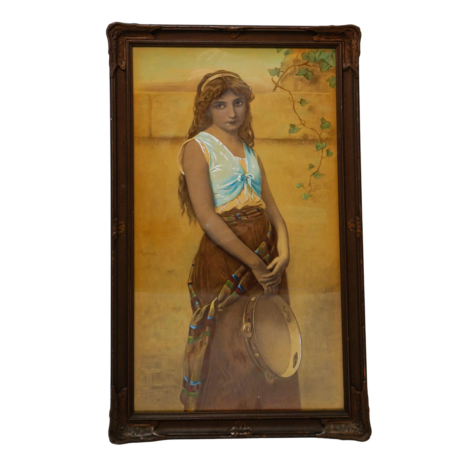 Portrait of Gypsy Girl Painting: Portrait of Gypsy Girl Painting19th century, EuropeAntique oil on paper portrait of a gypsy girl holding a tambourine. Sepia toned with accent colors throughout. Wooden frame with carved details at th