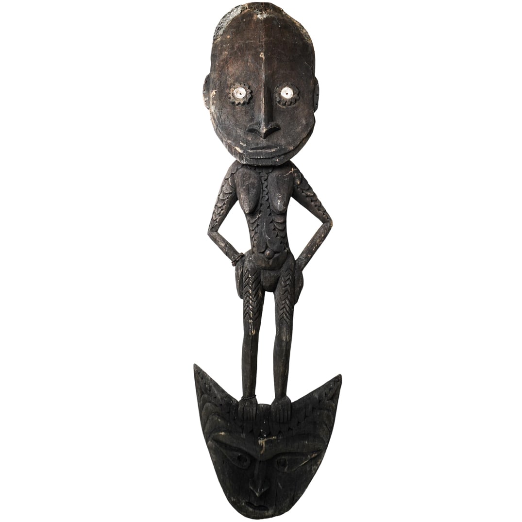 Tribal Ancestor Wooden Carved Figure: Tribal Ancestor Wooden Carved Figure Papua New Guinea, 19th century Carved wooden female standing on a figural carved face with shell accents on eyes and on the top of the head. Wire hardware on back 