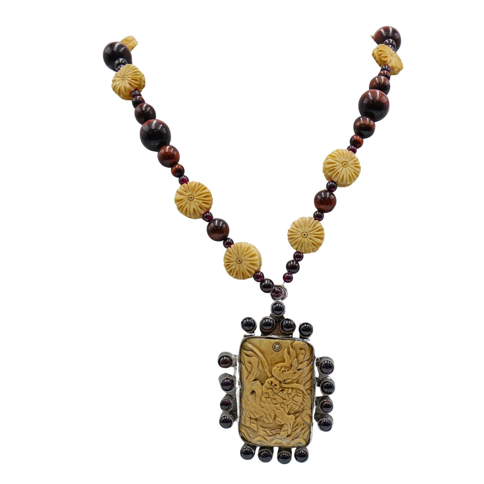 Antique Carved Bone and Amber Beaded Necklace: Antique Carved Bone and Amber Beaded Necklace20th century, ContinentalThis necklace is made of carved bone, featuring a pendant with dragon motifs, framed in silver-toned metal and accented with a rin