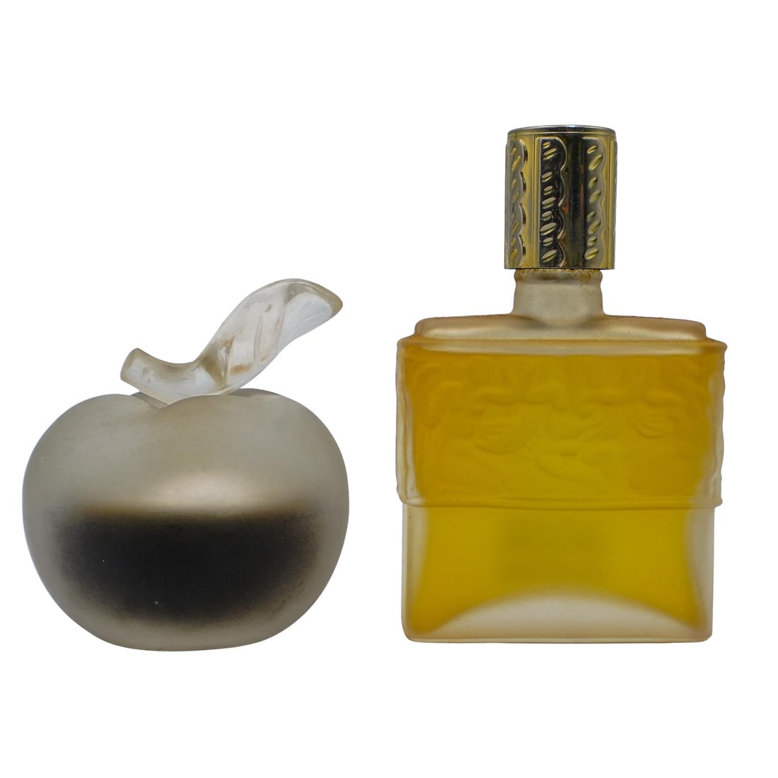 Pair of Lalique Perfume Bottles: Pair of Lalique Perfume Bottles 20th century, France Pair of Lalique perfume bottles. x1 Nina Ricci "Daughter of Eve" apple shaped bottle designed by Marc Lalique. Perfume is still inside. Marked on b