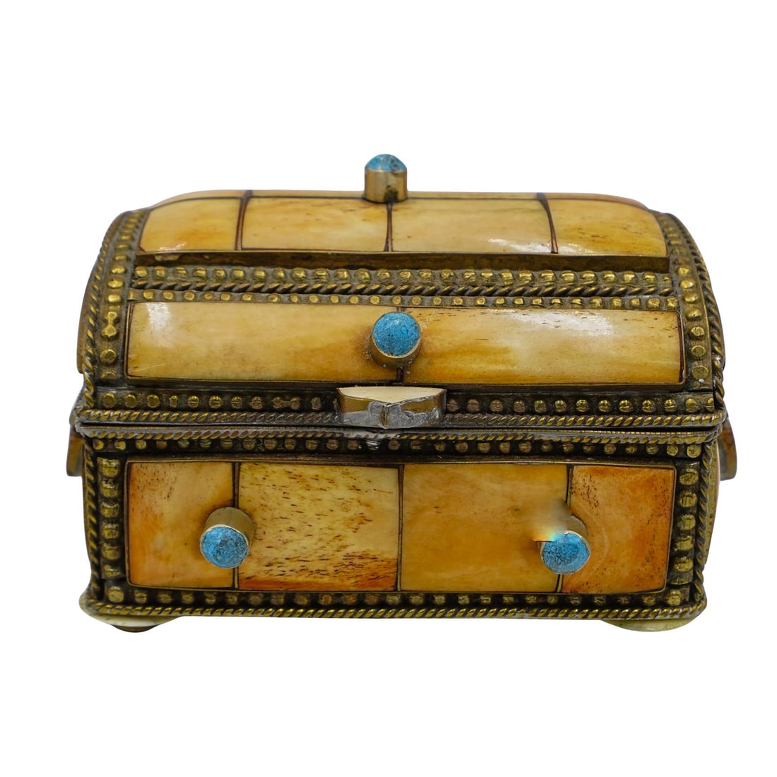 Antique Carved Camel Bone and Brass Box: Antique Carved Camel Bone and Brass Box20th century, ContinentalThis box is made of camel bone, arranged in rectangular segments and accented with gilded brass trim and small, round blue stones. The b