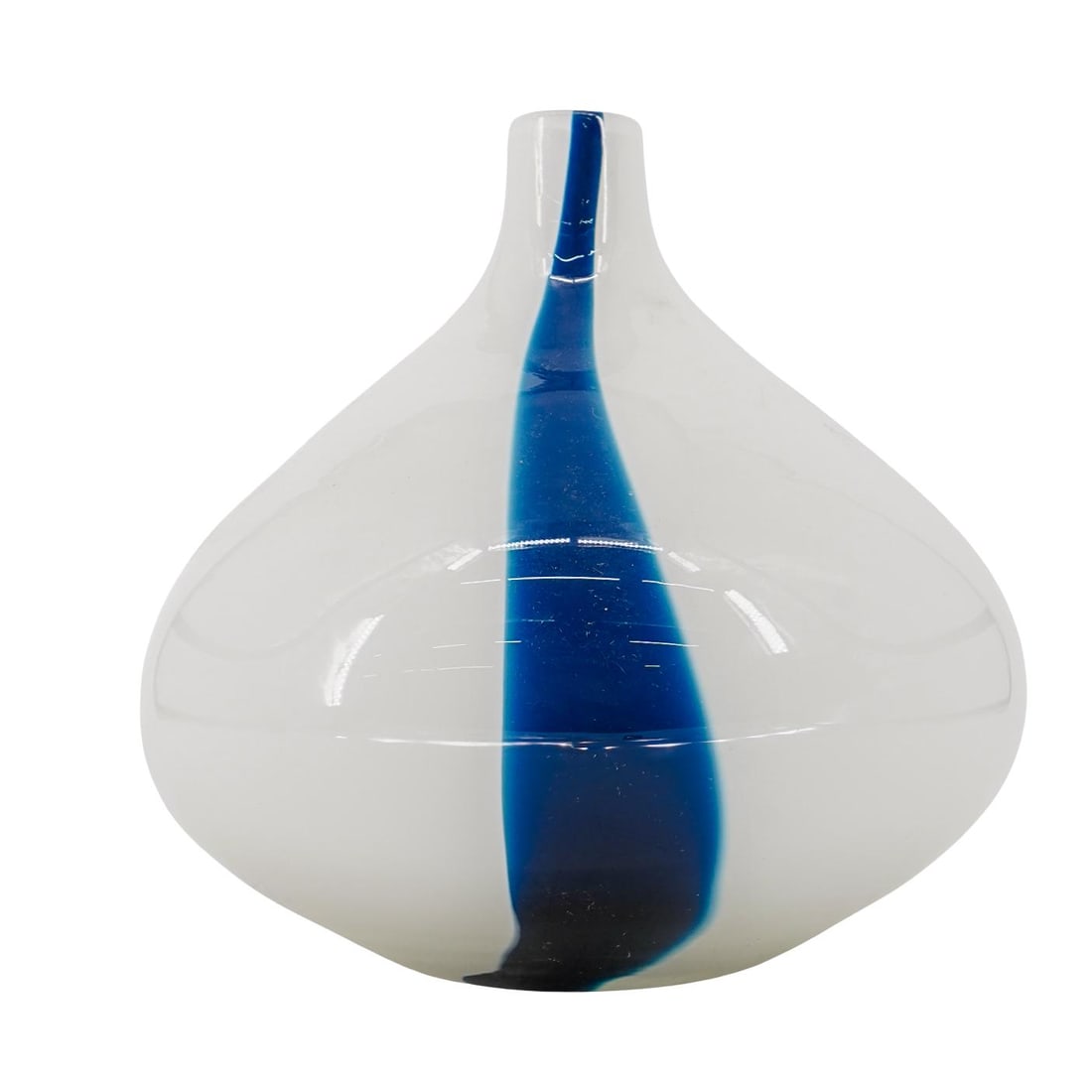 Murano White Art Glass Vase: Murano White Art Glass Vase 20th century, Italy The vase has a bulbous shape that tapers toward the neck. It is white with a single vertical blue stripe. H: 9" D: 1 1/4" L: 3 1/2"