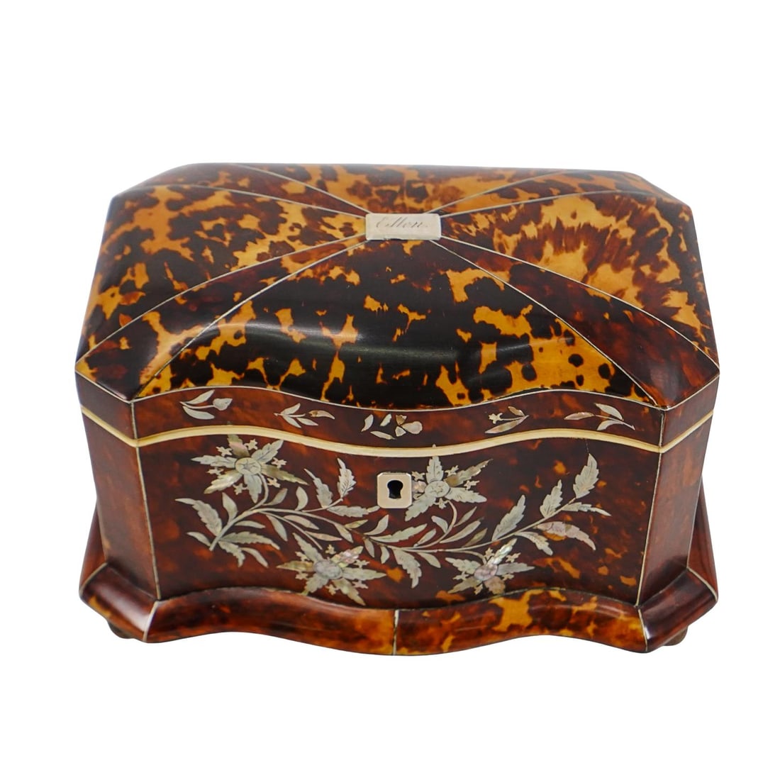 Antique English Tortoised Hued Tea Caddy: Antique English Tortoised Hued Tea Caddy 1860s, England Antique English tortoise hued tea caddy, featuring a repeated inlaid mother of pearl inlaid floral motif across the front, silver keyhole and si