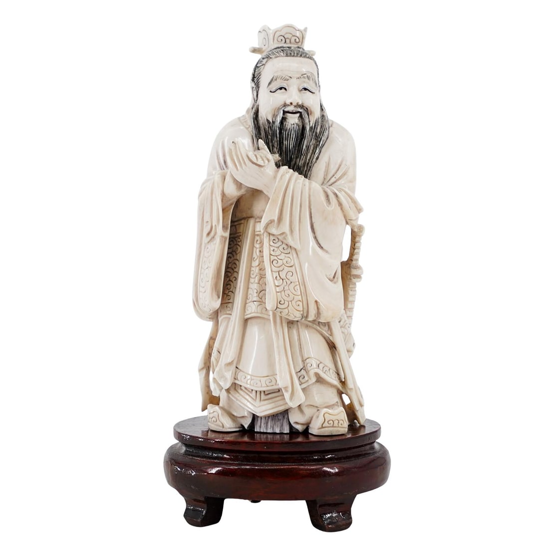 Antique Chinese Carved Bone Immortal Figurine: Antique Chinese Carved Bone Immortal Figurine20th Century, ChinaAntique Chinese Carved Bone Immortal Figurine depicting a robed figure with fine detailing in the facial features, attire, and posture.