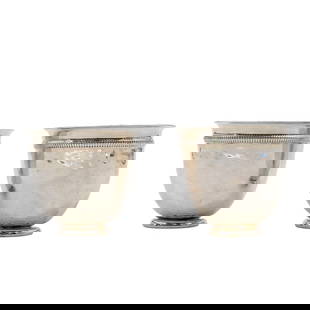(2 Pcs) Christian Dior Silver Plated Cups: (2 Pcs) Christian Dior Silver Plated Cups20th century, FranceA pair of small, round cups with a silver-plated exterior and a gold-toned interior. The rims feature a detailed, textured pattern, while t