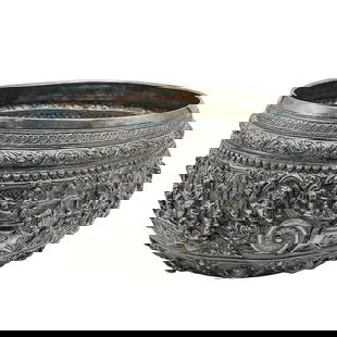 Antique Burmese Silver Offering Bowl: Antique Burmese Silver Offering BowlLate 19th Century, Burma (Myanmar)This Antique Burmese Silver Offering Bowl features intricate high-relief repoussé work depicting courtly and mythological scenes,