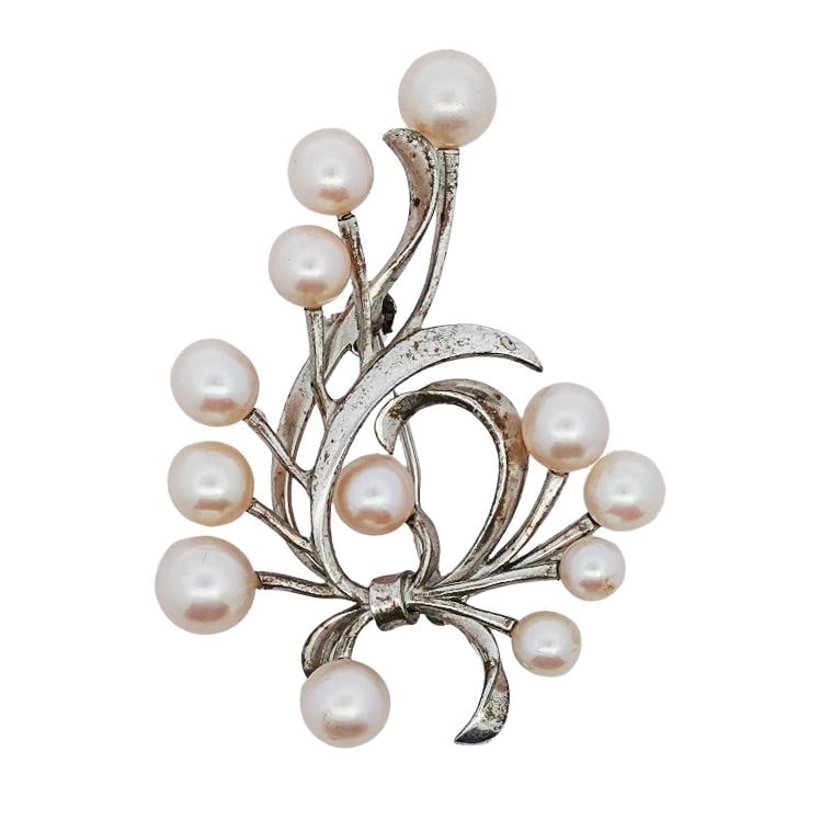 Mikimoto Sterling Silver Pearl Brooch: Mikimoto Sterling Silver Pearl Brooch20th Century, JapanThis elegant brooch by Mikimoto features a graceful arrangement of lustrous Akoya pearls set in flowing sterling silver tendrils. Renowned for t