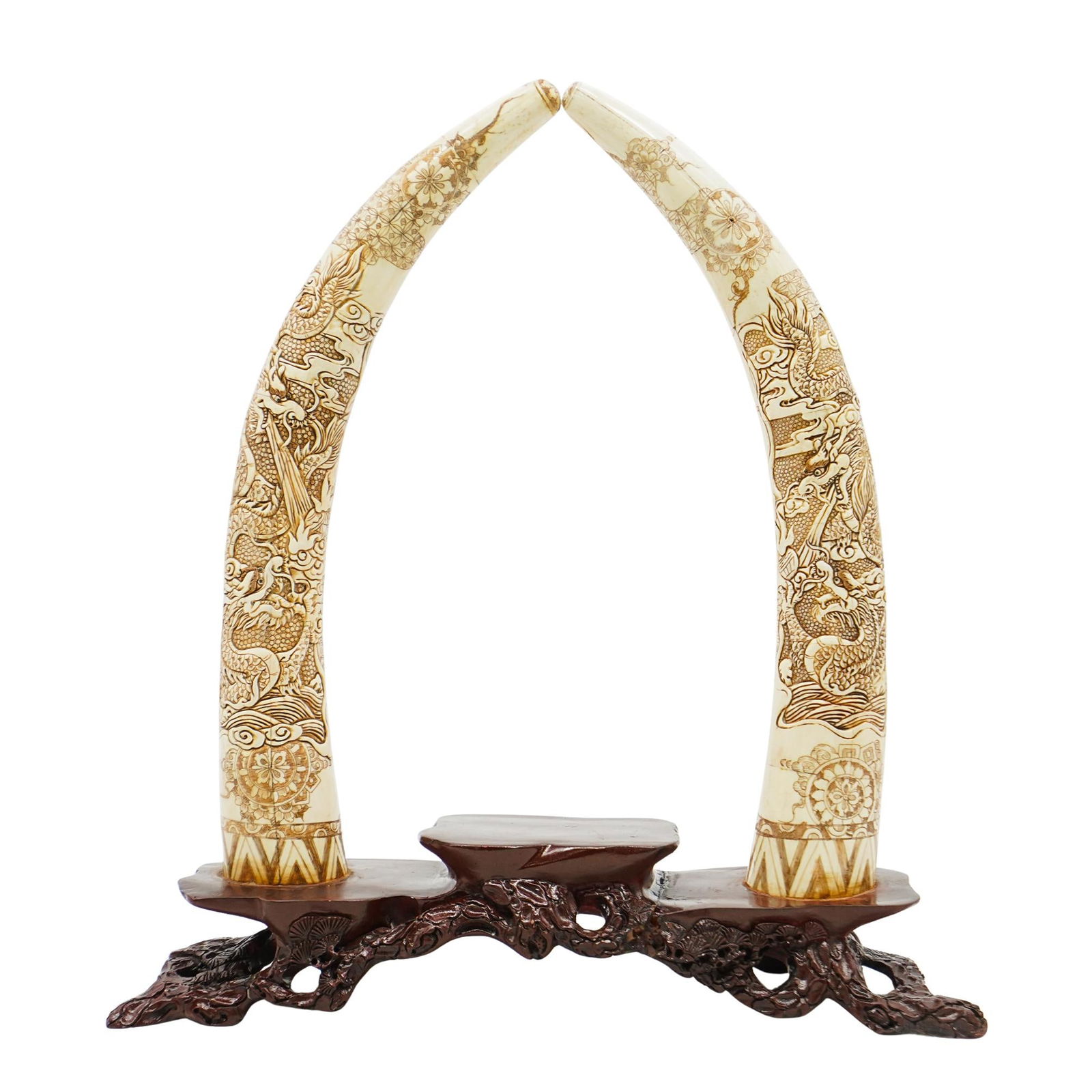Chinese Carved Bone Tusks Statue: Chinese Carved Bone Tusks StatueEarly 20th Cent., AsiaOrnate statue of two bone tusks featuring detailed geometric floral patterns. Each tusk is pieced together from individual panels and mounted to a