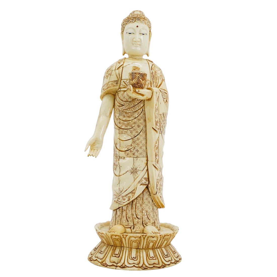 Antique Carved Bone Buddhist Statue: Antique Carved Bone Buddhist StatueMid to Late 19th c., AsiaHand carved bone figure of the Shakyamuni Buddha standing on a platform with robes decorated in intricate patterns and highly detailed featu