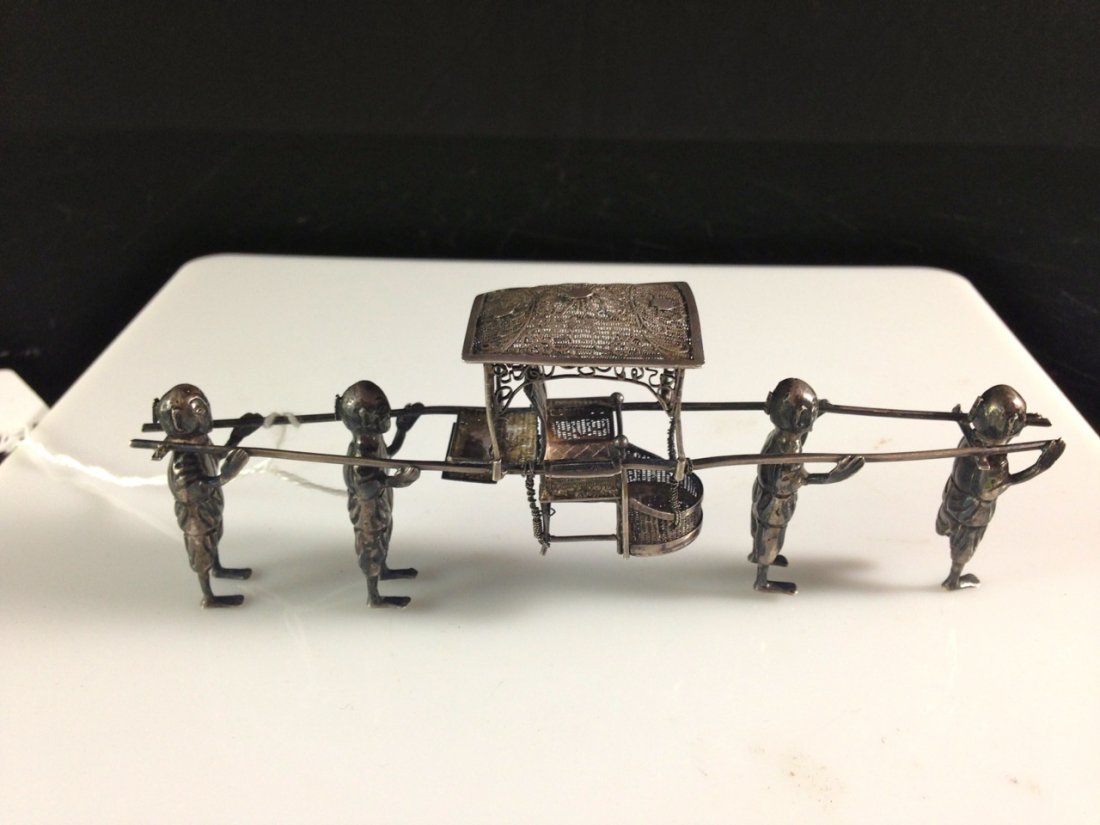 Antique Chinese 900 silver "sedan chair". Signed: DESCRIPTION: Antique Chinese 900 silver "sedan chair". Hand crafted solid silver piece featuring four men carrying an ornate silver filigree sedan chair. Great attention to detail. Hallmarked "HM 90" 